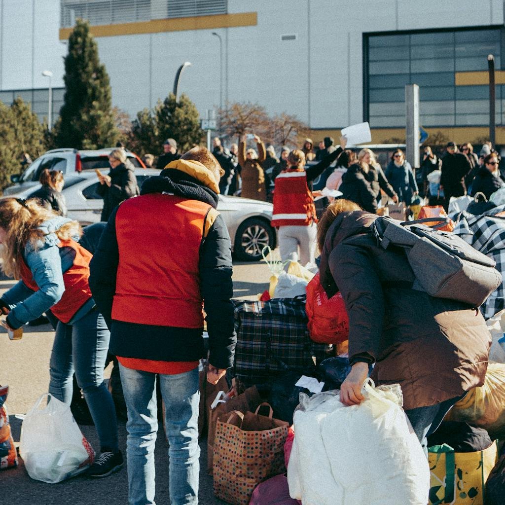 Group of individuals sorting donations outside in Vilnius, Lithuania on a sunny day.