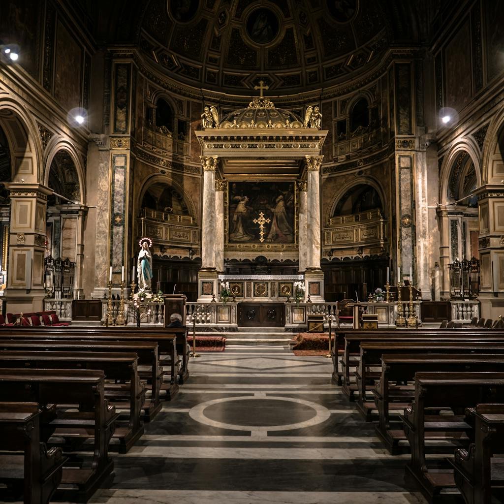 Interior view of a Gothic-style basilica in Rome, showcasing intricate architecture and religious art.